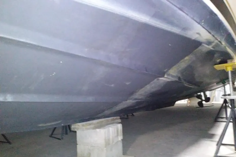 Slide: The Image of 1993 Tiara 3100 Open boat hull in storage, supported by blocks and stands. - 36