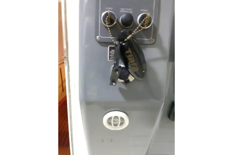 Slide: The Image of Keys hanging on a Tiara 3100 Open 1993 boat control panel. - 37