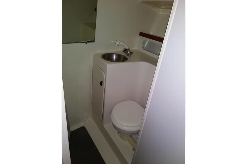 Slide: The Image of Compact bathroom in 1993 Tiara 3100 Open boat, featuring sink and toilet. - 38