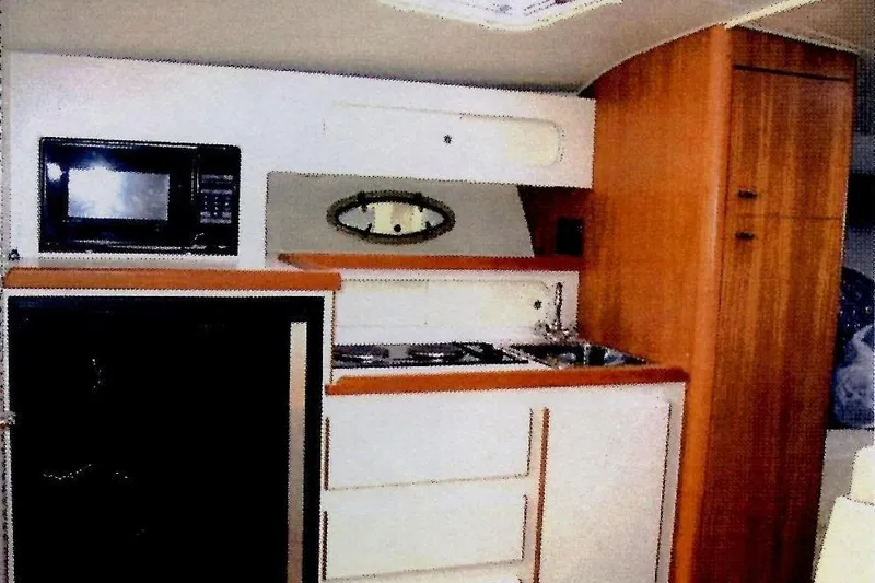 Slide: The Image of Interior of a 1993 Tiara 3100 Open yacht kitchen with microwave and cabinetry. - 5