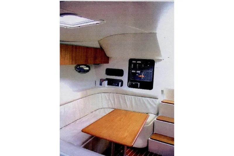 Slide: The Image of Interior of 1993 Tiara 3100 Open yacht with wood table and white seating. - 6