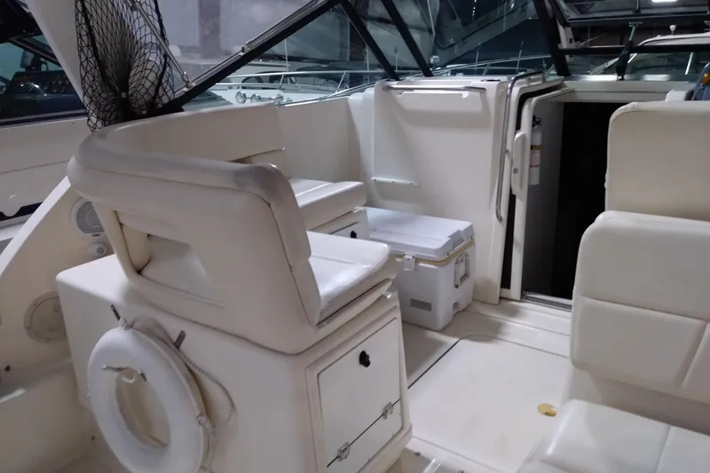 Slide: The Image of 1993 Tiara 3100 Open boat interior with white seating and storage compartments. - 8