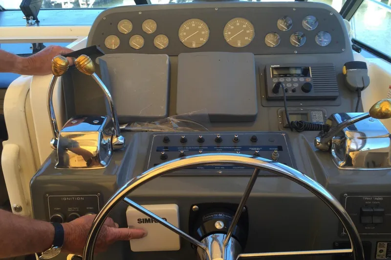 Slide: The Image of Control panel of a 1993 Tiara 3100 Open boat with steering wheel and gauges. - 9