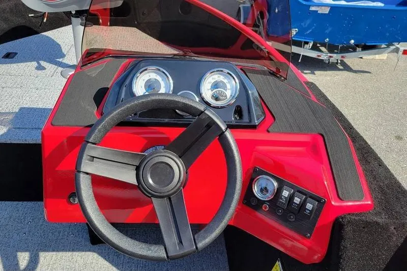 Slide: The Image of 2026 Smoker Craft Lazer 161 boat dashboard with steering wheel and gauges. - 7