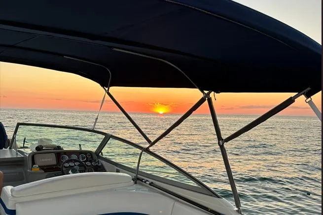 Slide: The Image of 2002 Formula 330 Sun Sport boat cruising at sunset on open water. - 10