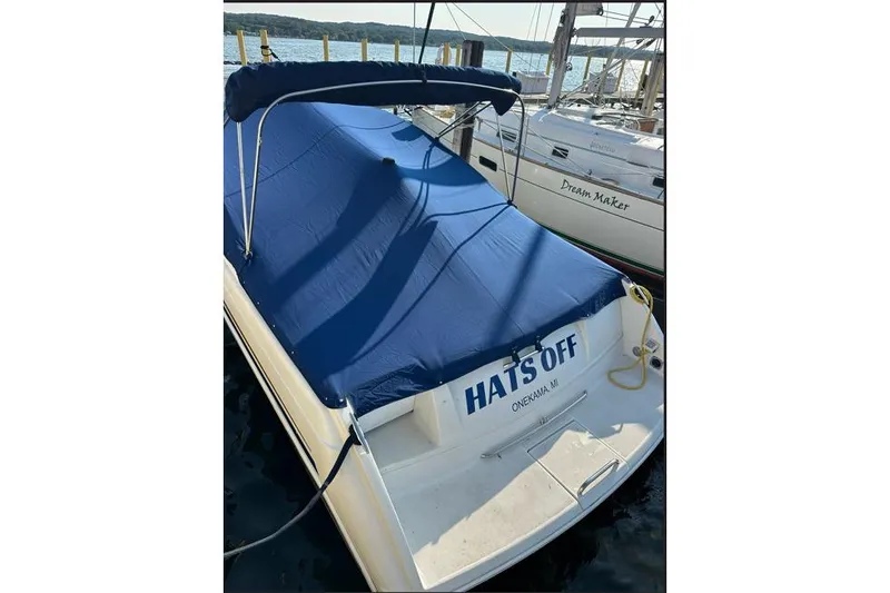 Slide: The Image of 2002 Formula 330 Sun Sport boat named "Hats Off" docked with blue cover. - 3