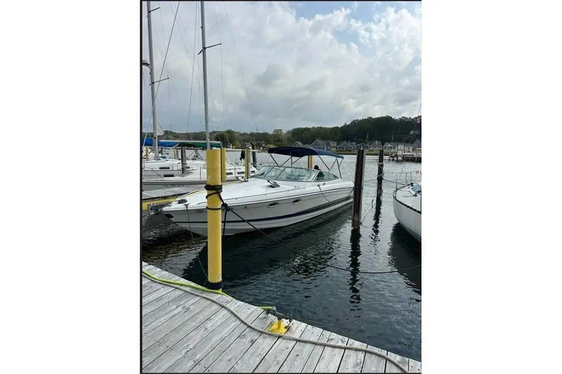 Slide: The Image of 2002 Formula 330 Sun Sport boat docked at a marina under cloudy skies. - 5