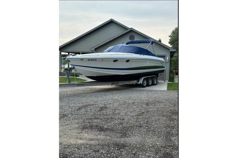 Slide: The Image of 2002 Formula 330 Sun Sport boat on trailer, parked in front of a garage. - 7