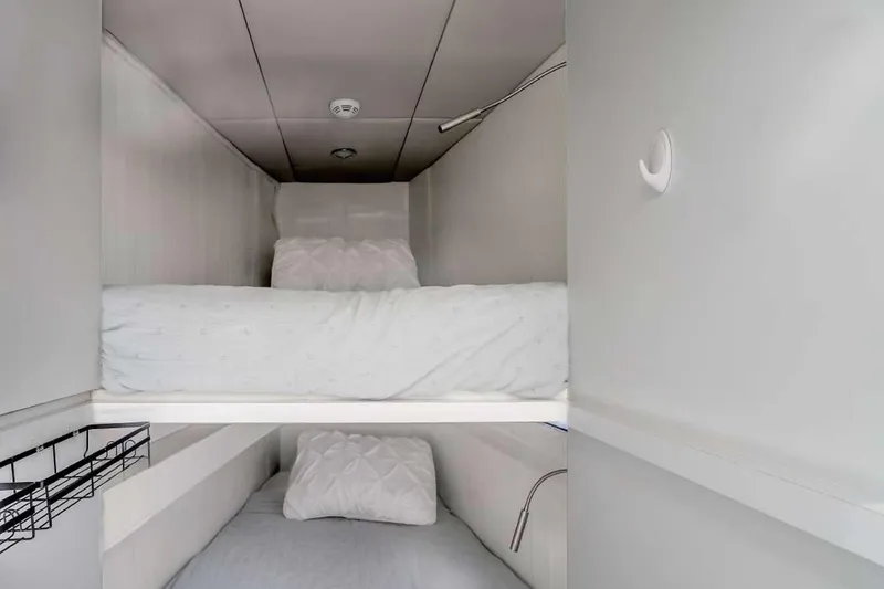 Slide: The Image of Bunk beds in 2021 Sunreef Supreme 68 Power yacht cabin, featuring modern design and cozy bedding. - 10