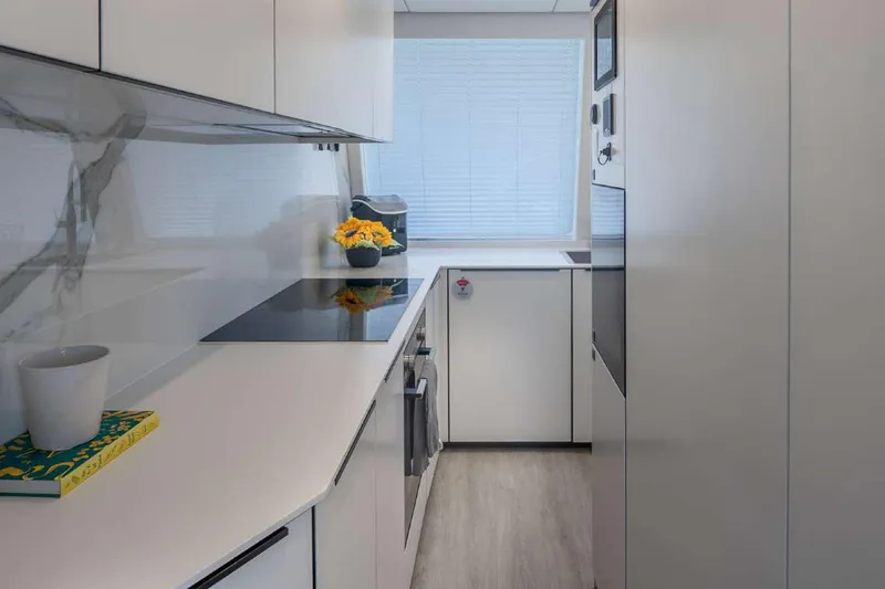 Slide: The Image of Modern kitchen interior on 2021 Sunreef Supreme 68 Power yacht, featuring sleek design and appliances. - 13