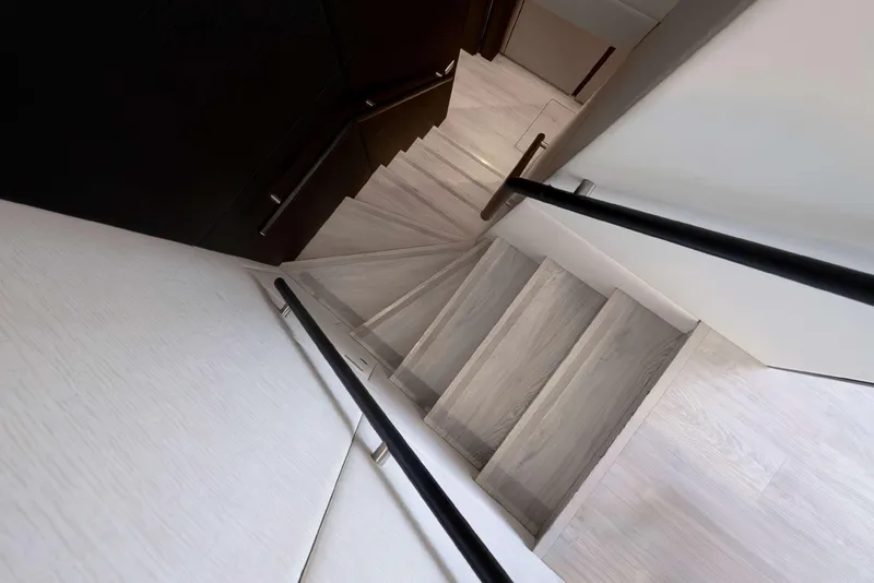 Slide: The Image of Staircase inside 2021 Sunreef Supreme 68 Power yacht, featuring sleek wooden steps and modern design. - 14