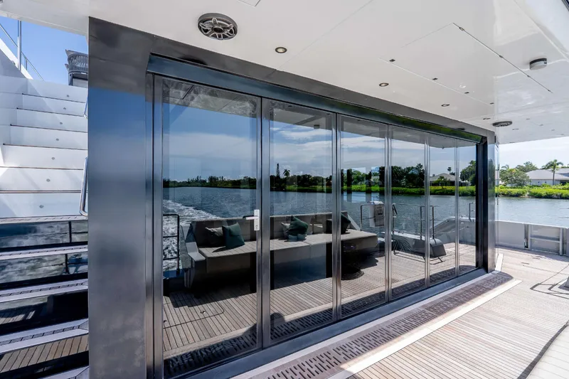 Slide: The Image of Luxurious Sunreef Supreme 68 Power yacht with sleek glass doors and scenic water view. - 40