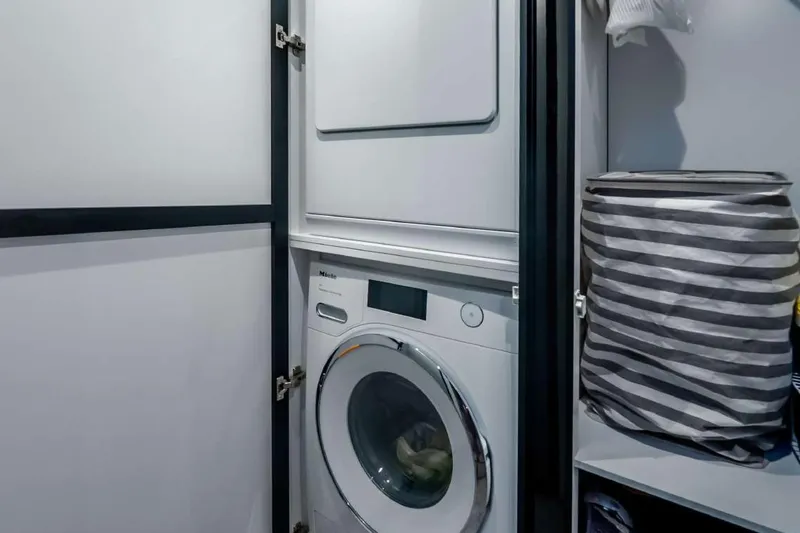Slide: The Image of Laundry area with washer and dryer on Sunreef Supreme 68 Power yacht, 2021 model. - 8