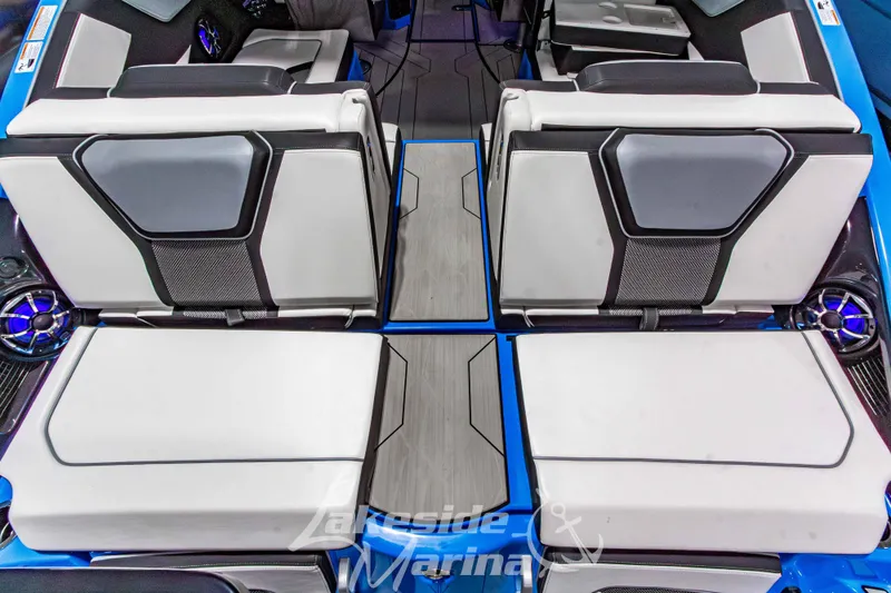 Slide: The Image of 2023 Yamaha Boats 255XE interior seating with modern design and blue accents. - 14