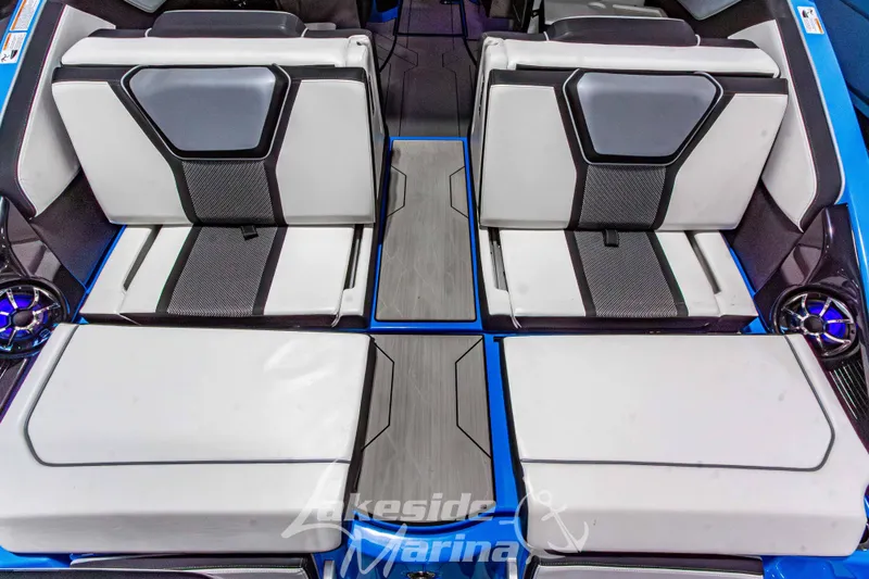 Slide: The Image of 2023 Yamaha Boats 255XE interior seating with modern design and blue accents. - 15