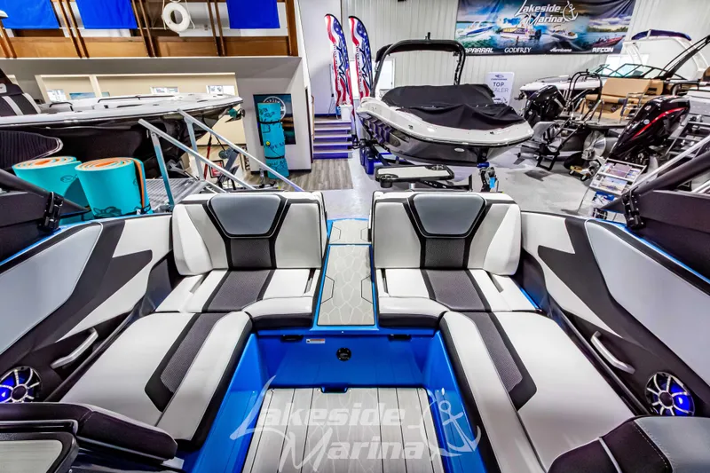 Slide: The Image of 2023 Yamaha Boats 255XE interior with sleek seating at Lakeside Marina showroom. - 20