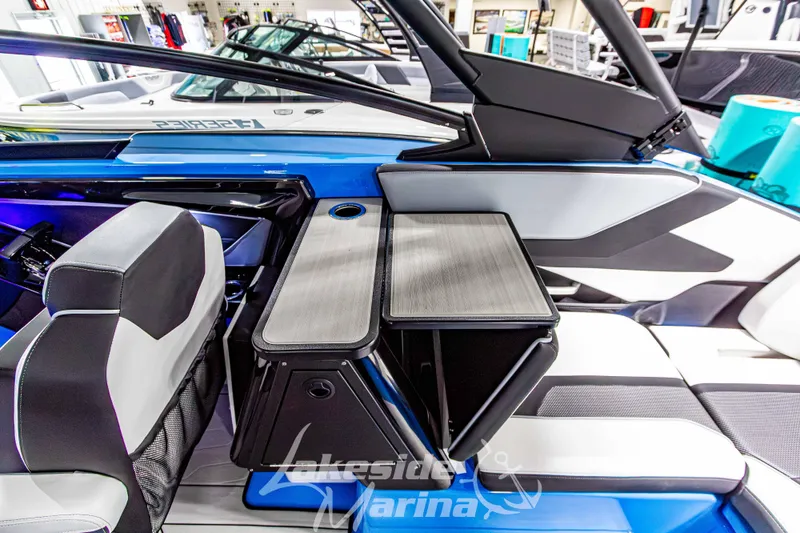 Slide: The Image of 2023 Yamaha Boats 255XE interior with sleek seating and modern table design. - 24