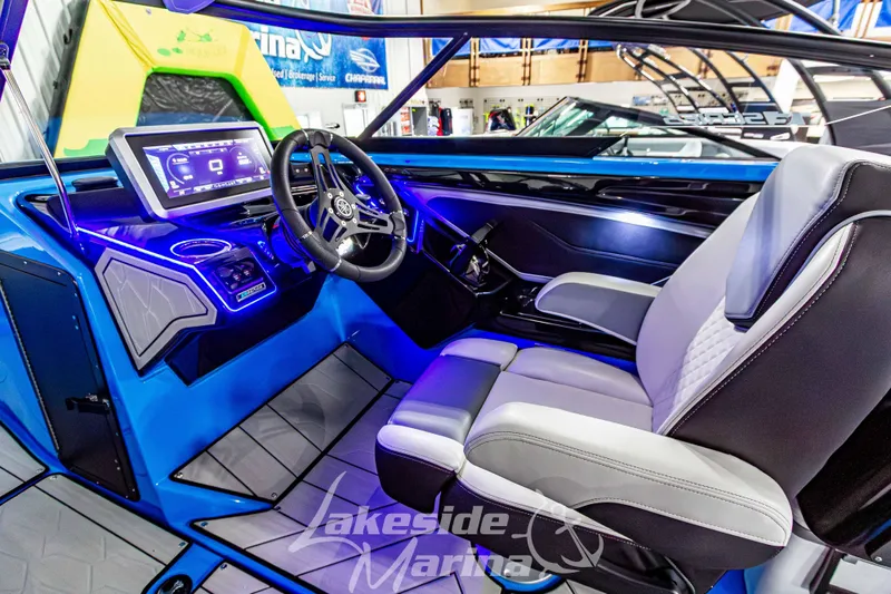 Slide: The Image of 2023 Yamaha Boats 255XE cockpit with modern dashboard and luxurious seating at Lakeside Marina. - 30