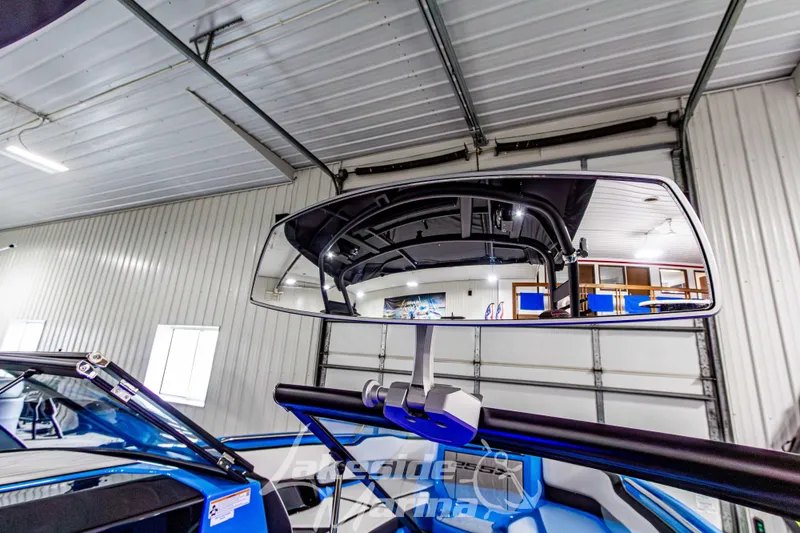 Slide: The Image of 2023 Yamaha Boats 255XE rearview mirror in a garage setting. - 32