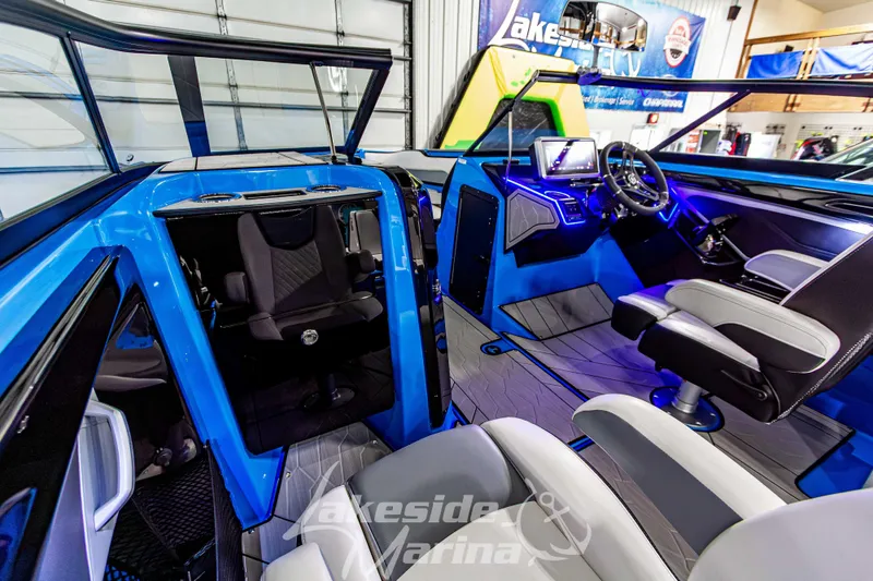 Slide: The Image of 2023 Yamaha Boats 255XE interior with modern dashboard and seating at Lakeside Marina. - 38