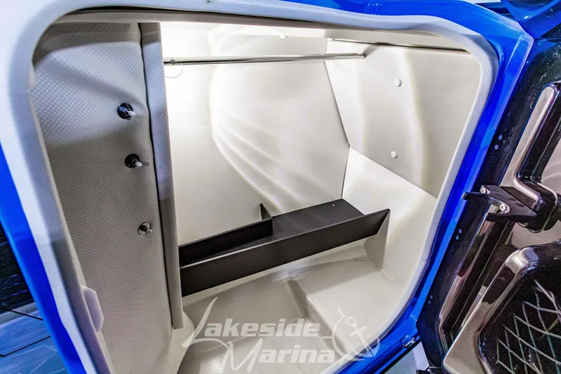 Slide: The Image of 2023 Yamaha Boats 255XE storage compartment with sleek interior design. - 40