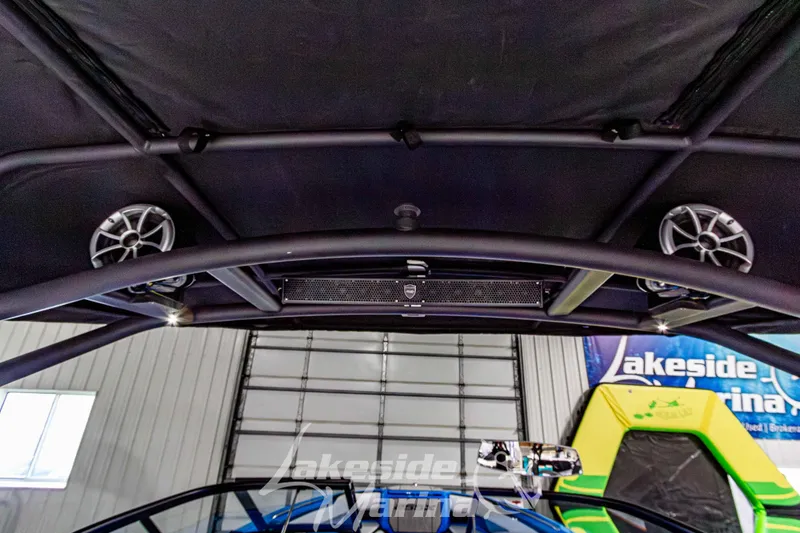 Slide: The Image of 2023 Yamaha Boats 255XE interior with speakers and canopy at Lakeside Marina. - 41