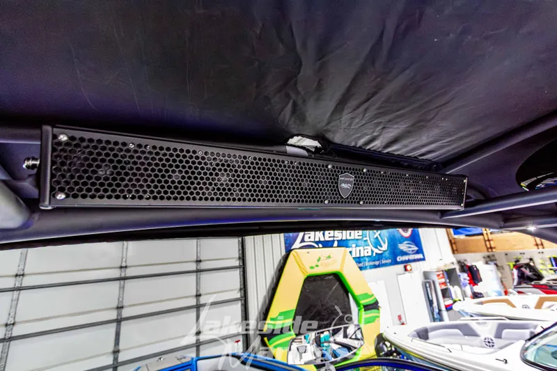 Slide: The Image of 2023 Yamaha Boats 255XE interior with premium sound system in a showroom. - 42