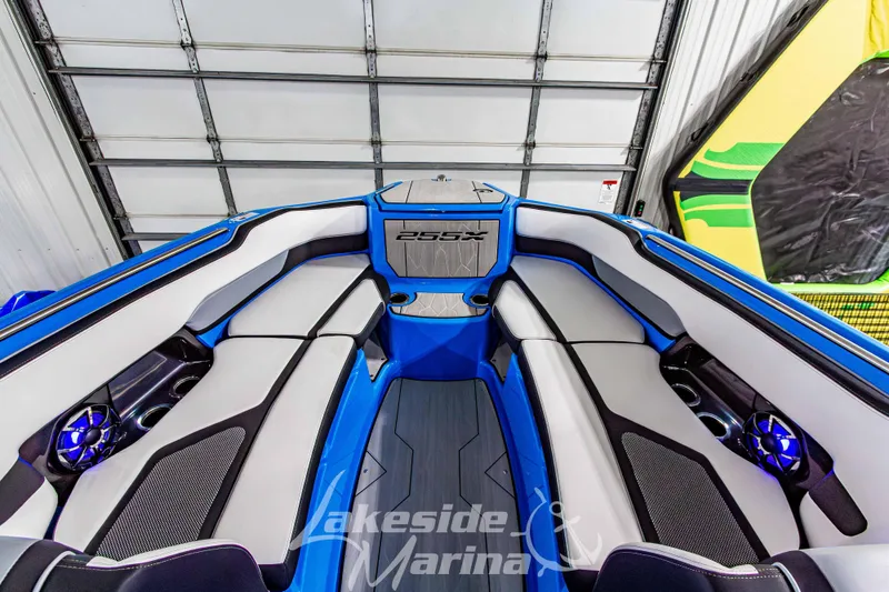 Slide: The Image of 2023 Yamaha Boats 255XE interior with blue and gray seating, Lakeside Marina branding. - 45
