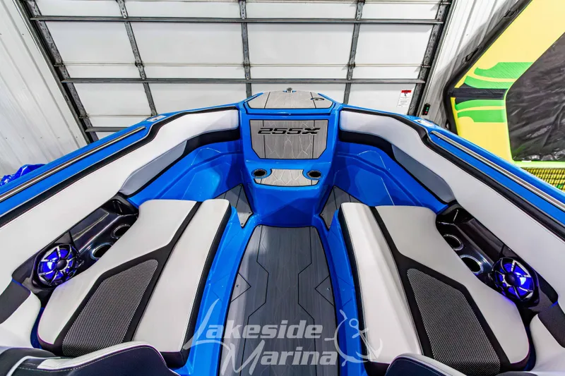 Slide: The Image of 2023 Yamaha Boats 255XE interior with blue and gray seating, modern design, and audio system. - 46