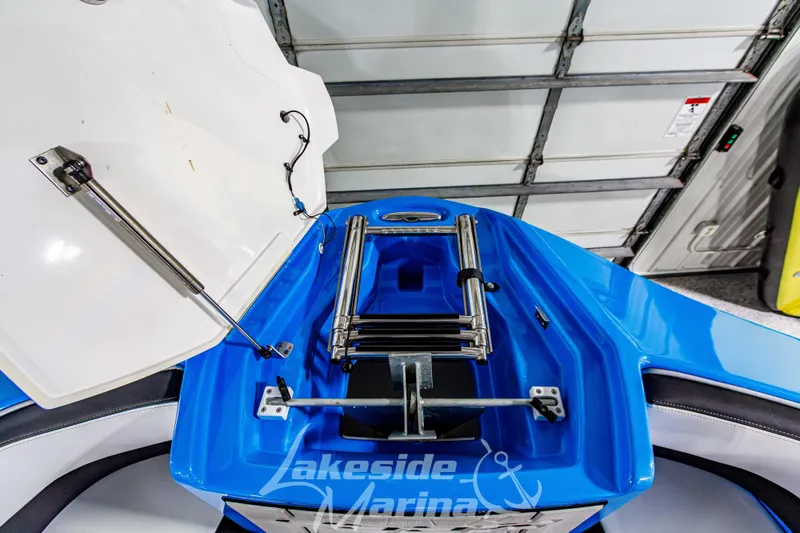 Slide: The Image of 2023 Yamaha Boats 255XE with open storage compartment and ladder, Lakeside Marina. - 49