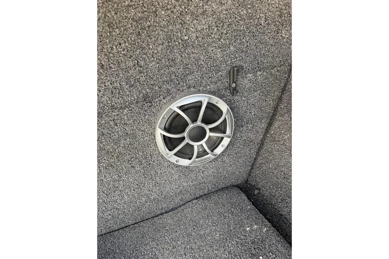 Slide: The Image of Speaker installed in 2012 Tigé R20 boat interior with gray carpeted surface. - 19