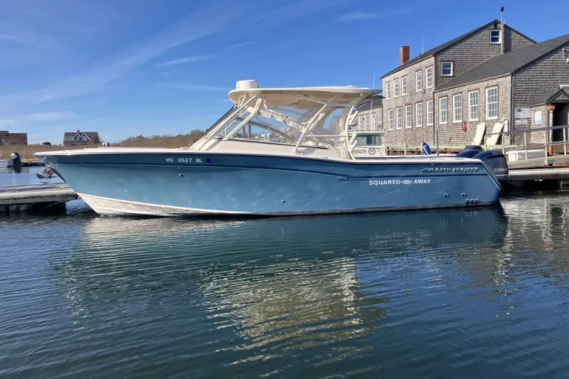 The Image of 2019 Grady-White Freedom 307 boat docked by a waterfront building. - 1