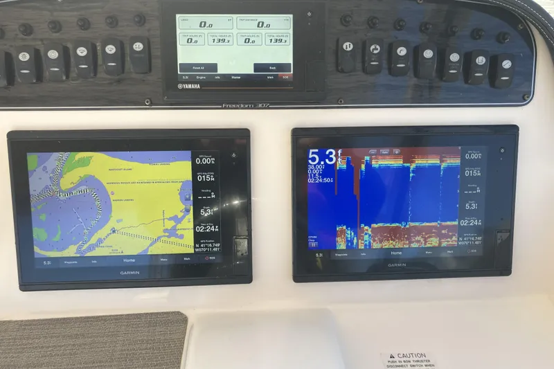 Slide: The Image of Grady-White Freedom 307 dashboard with Garmin navigation and sonar displays, 2019 model. - 13