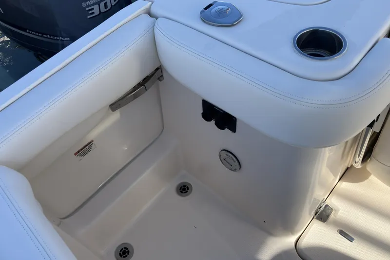 Slide: The Image of 2019 Grady-White Freedom 307 boat interior with white seating and cup holder. - 16