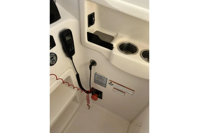 Slide: The Image of 2019 Grady-White Freedom 307 boat interior with control panel and cup holders. - 17