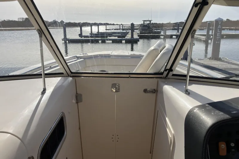 Slide: The Image of 2019 Grady-White Freedom 307 boat interior view at marina dock. - 18