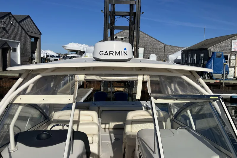 Slide: The Image of 2019 Grady-White Freedom 307 boat docked, featuring Garmin equipment. - 22