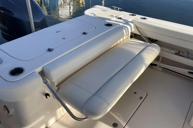 Slide: The Image of 2019 Grady-White Freedom 307 boat interior with white seating and cup holders. - 23