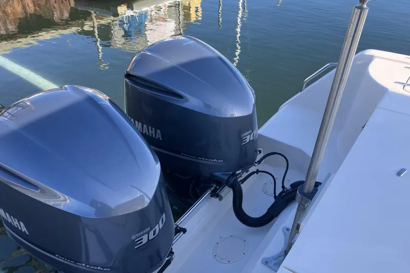 Slide: The Image of 2019 Grady-White Freedom 307 with twin Yamaha 300 outboard engines on calm water. - 27