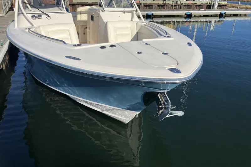 Slide: The Image of 2019 Grady-White Freedom 307 boat docked on calm water. - 3