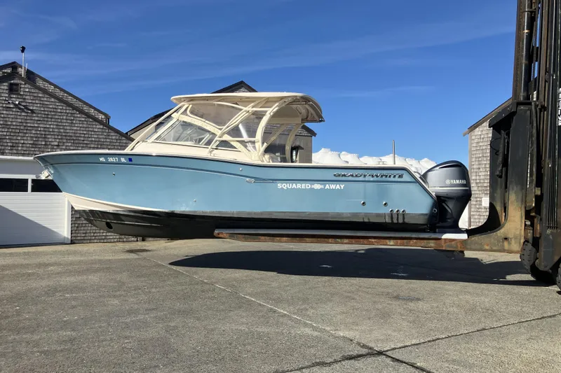 Slide: The Image of 2019 Grady-White Freedom 307 boat on forklift, blue hull, Yamaha engines, sunny day. - 6