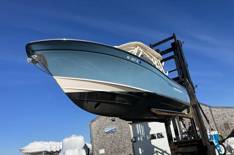 Slide: The Image of 2019 Grady-White Freedom 307 boat lifted against clear blue sky. - 7