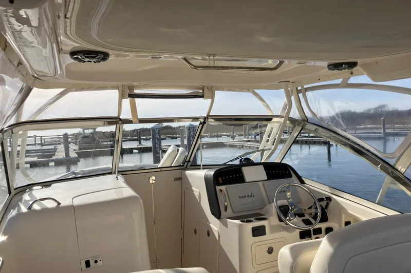 Slide: The Image of 2019 Grady-White Freedom 307 boat interior with Garmin navigation, docked at marina. - 9