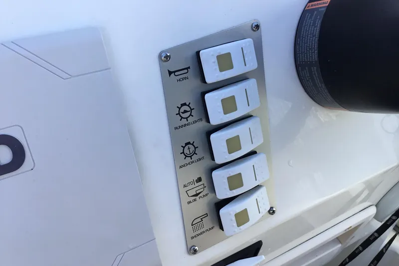 Slide: The Image of Control panel of a 2018 Brig E 480 boat with labeled switches. - 12