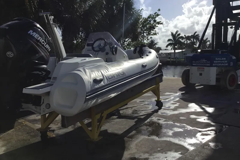 Slide: The Image of 2018 Brig E 480 inflatable boat with Mercury engine on dockside stand. - 4