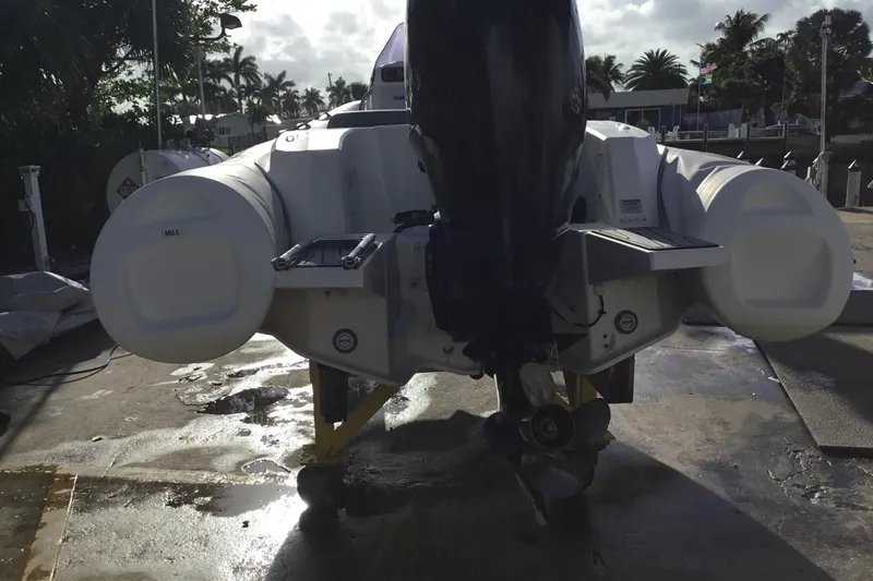 Slide: The Image of 2018 Brig E 480 inflatable boat with outboard motor, docked on a sunny day. - 5