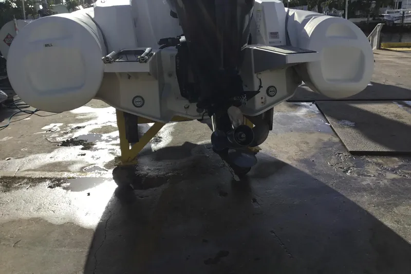 Slide: The Image of Rear view of a 2018 Brig E 480 boat on a wet dock surface. - 6