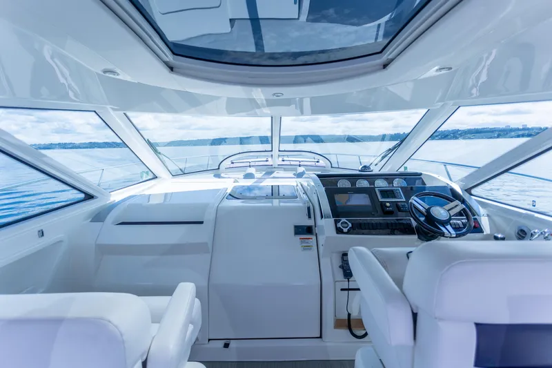Slide: The Image of Interior view of 2011 Sea Ray 450 Sundancer yacht cockpit with panoramic windows. - 14