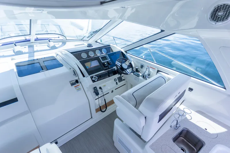 Slide: The Image of Interior view of 2011 Sea Ray 450 Sundancer yacht cockpit with modern controls and seating. - 15