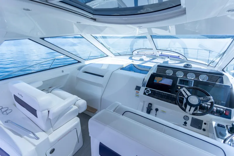 Slide: The Image of Interior of 2011 Sea Ray 450 Sundancer yacht with modern helm and seating. - 19